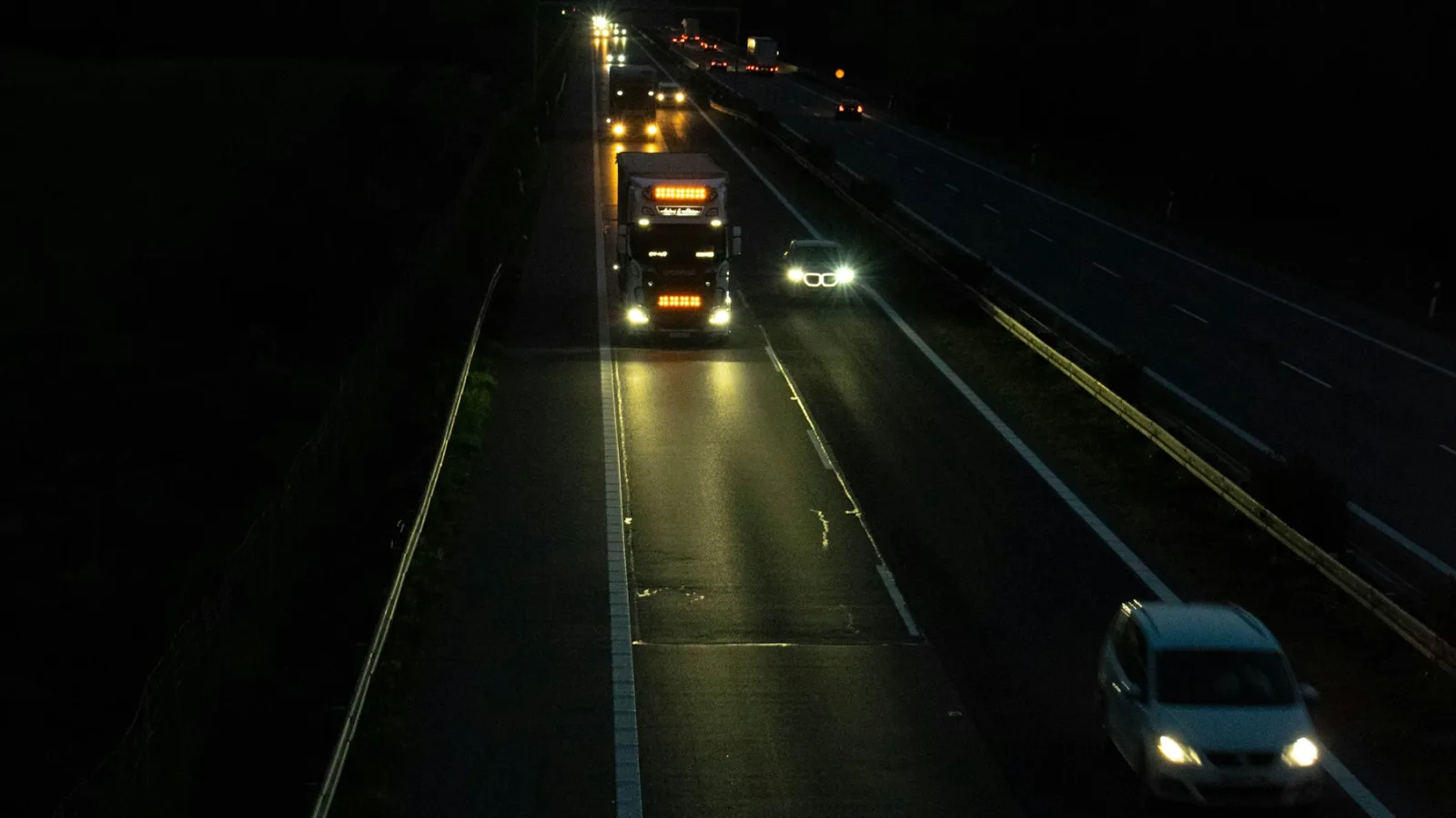 Gece otoyolda ilerleyen iki tır ve araç trafiği
